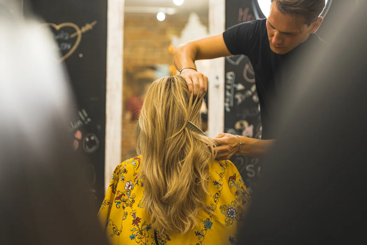 Blonde layered long hair in the professional hair salon