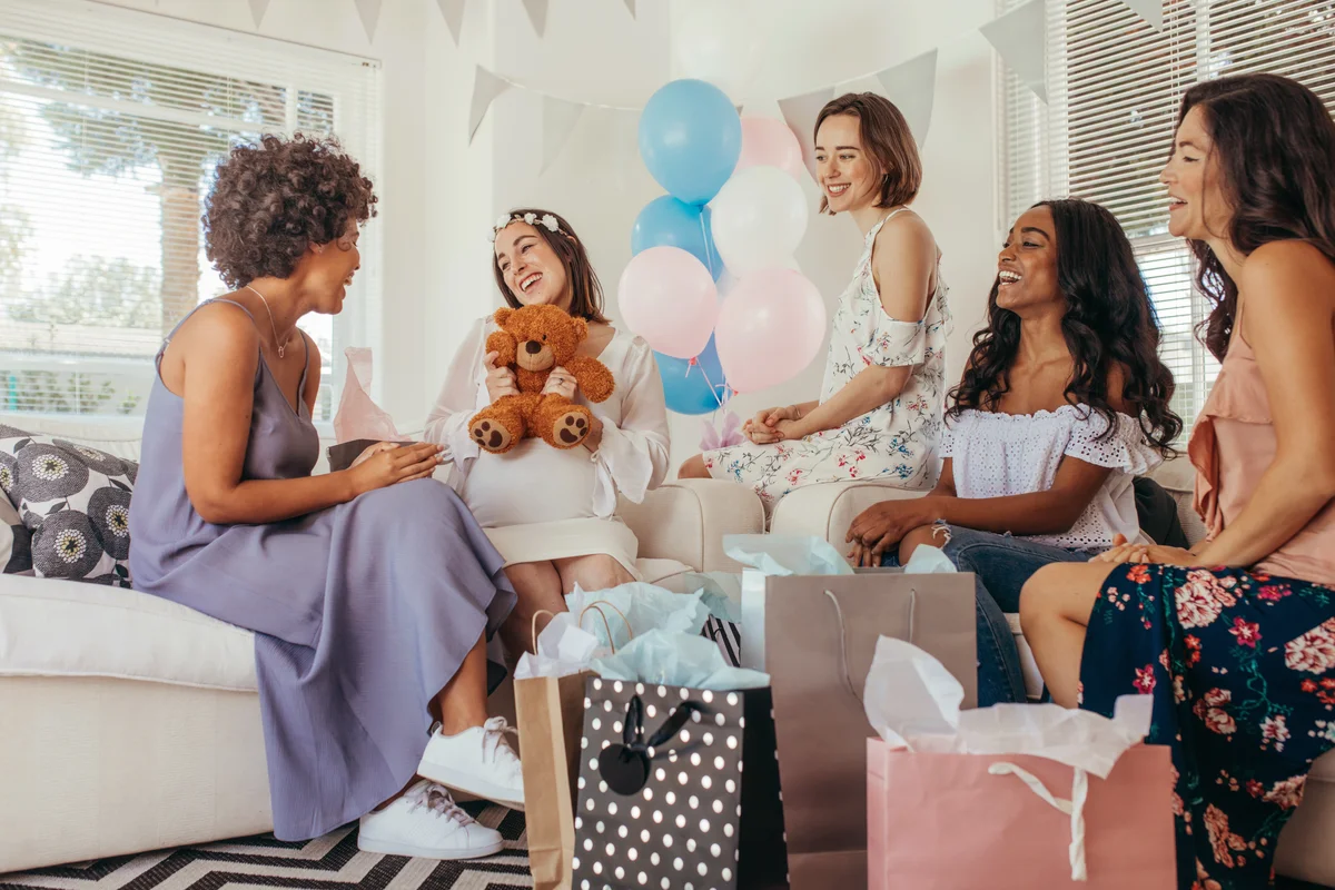Pregnant woman celebrating baby shower party with friends