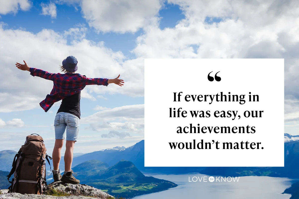 Hiker with her arms outstretched at the top of the mountain