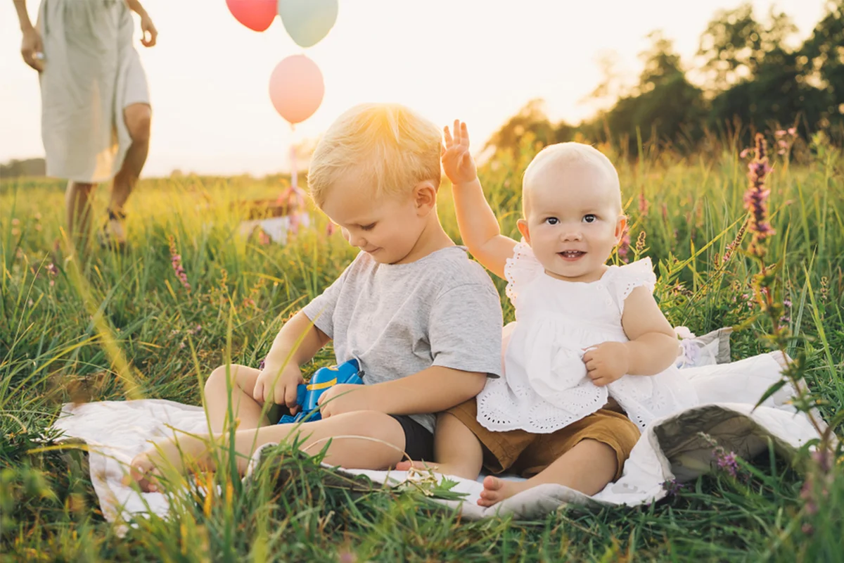 Siblings together on a field