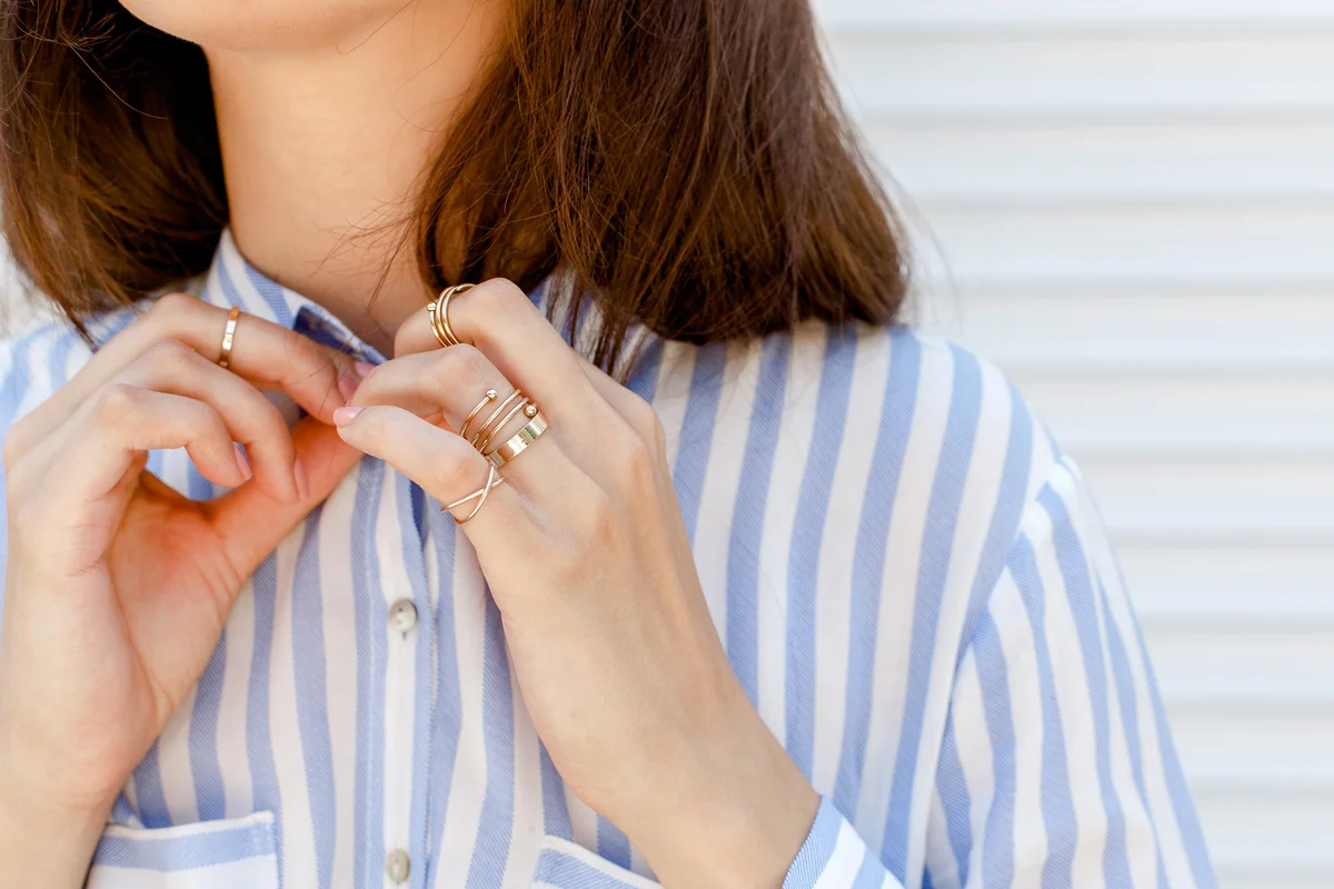 Woman wearing multiple rings on her fingers