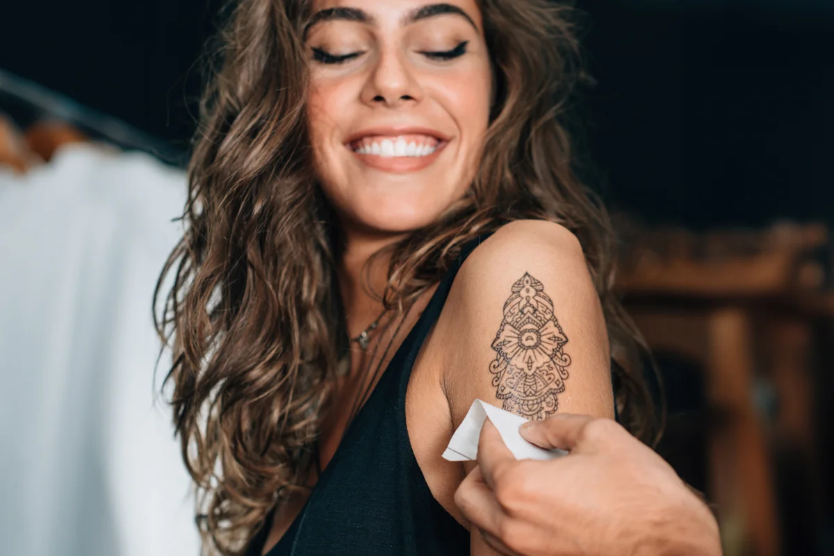 Satisfied girl with new temporary tattoo