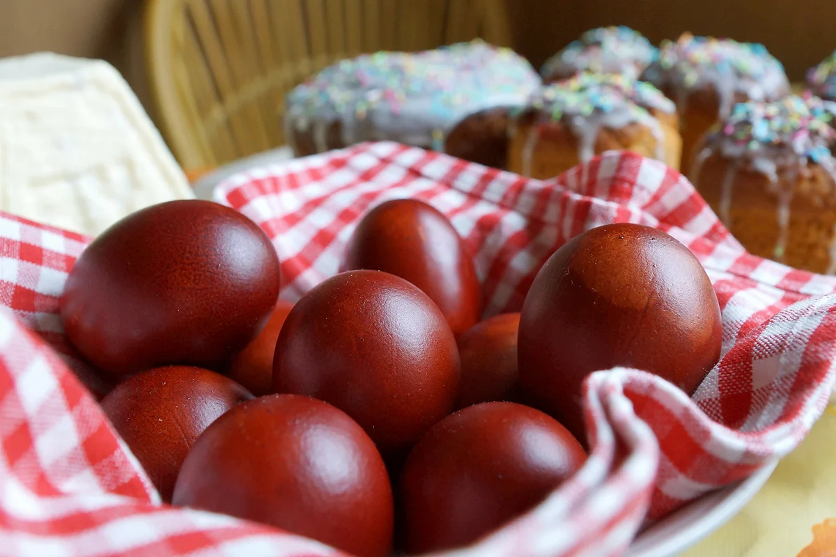 Red Easter eggs and Easter cakes on a table