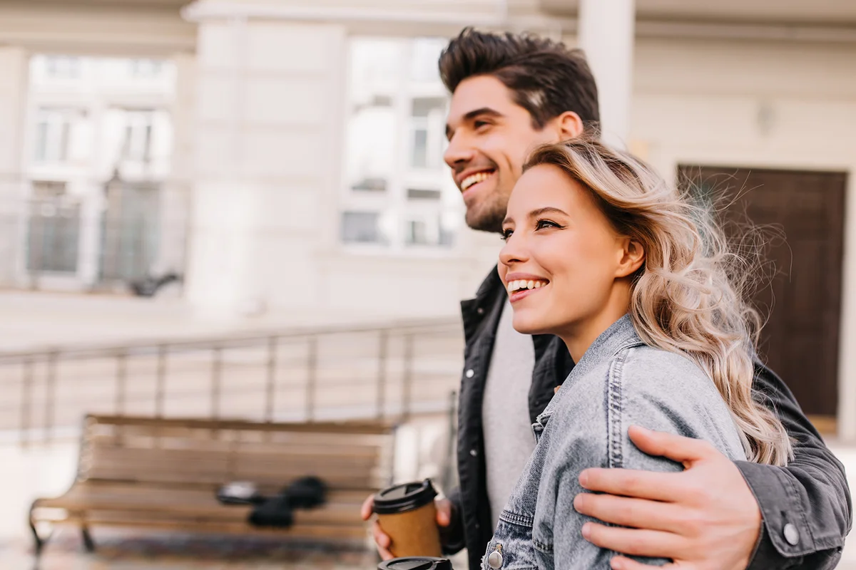 Couple walking with coffee