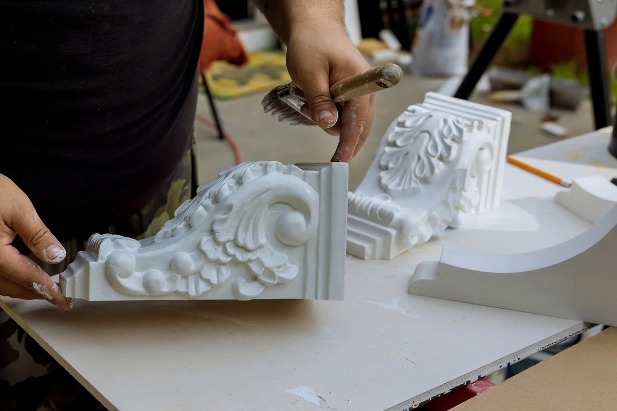 Worker painting corbels