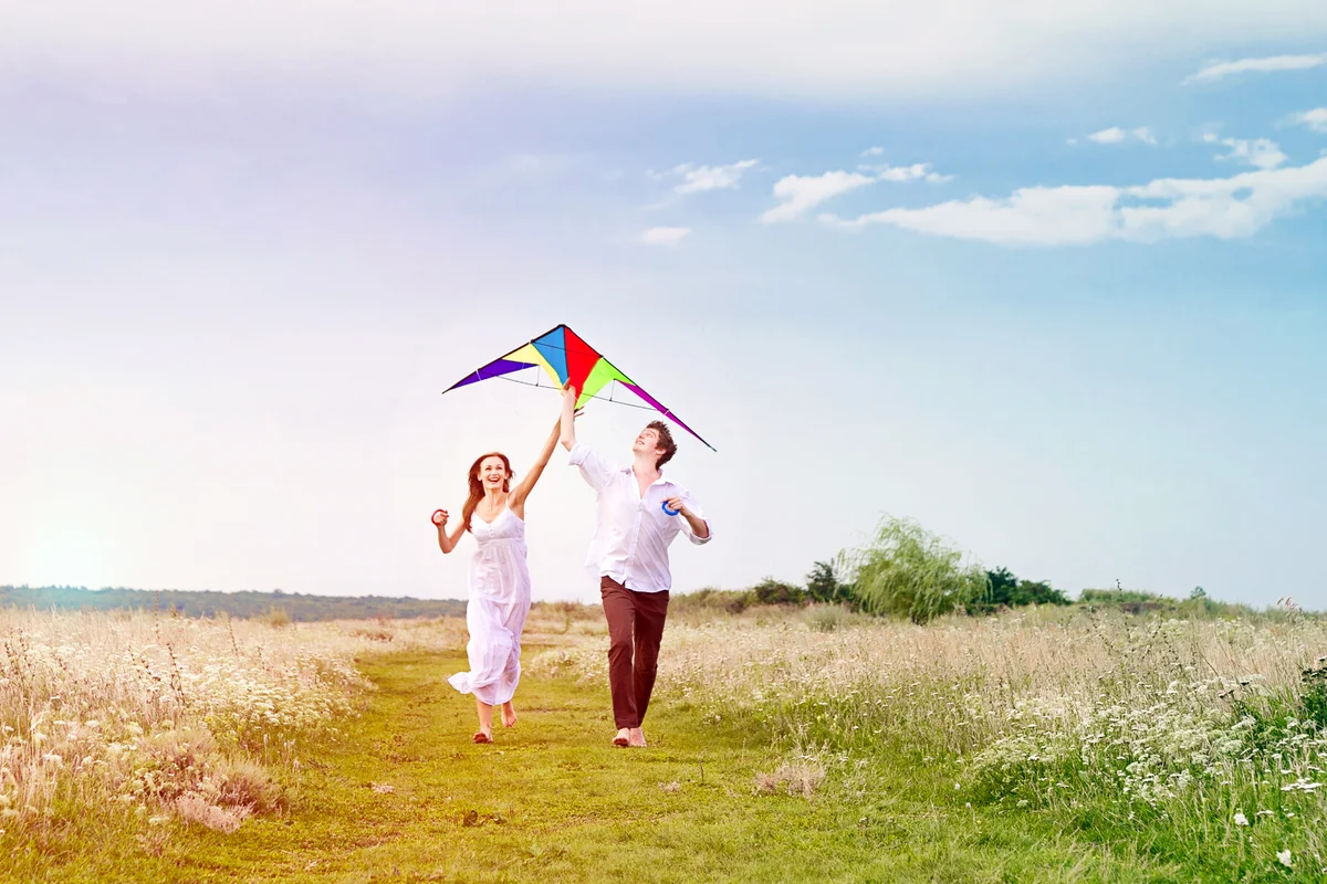 Young couple in love flying a kite