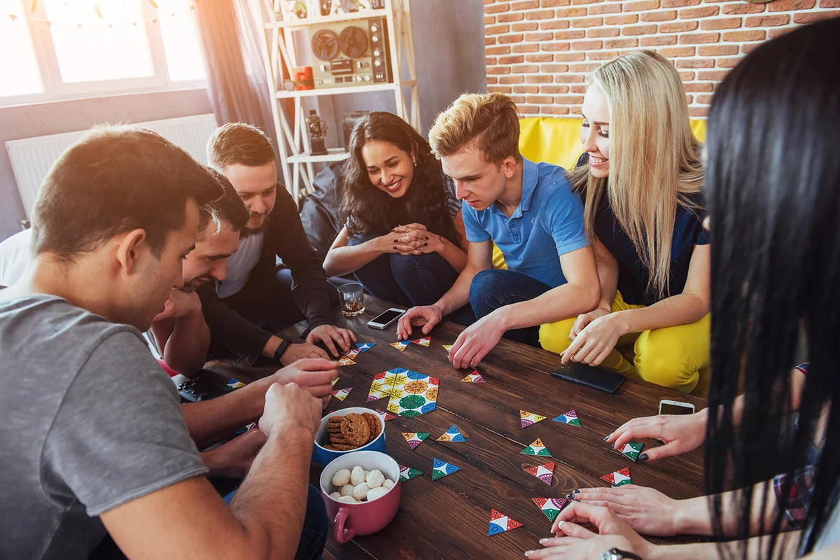 Friends having fun while playing board game