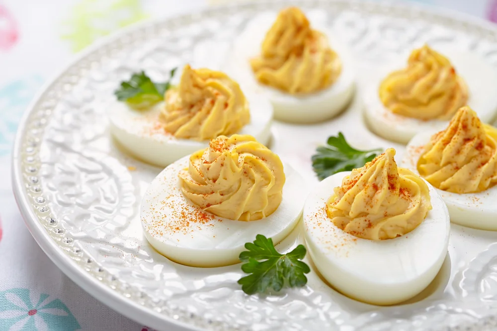 Detail shot of Deviled Eggs over a white vintage plate