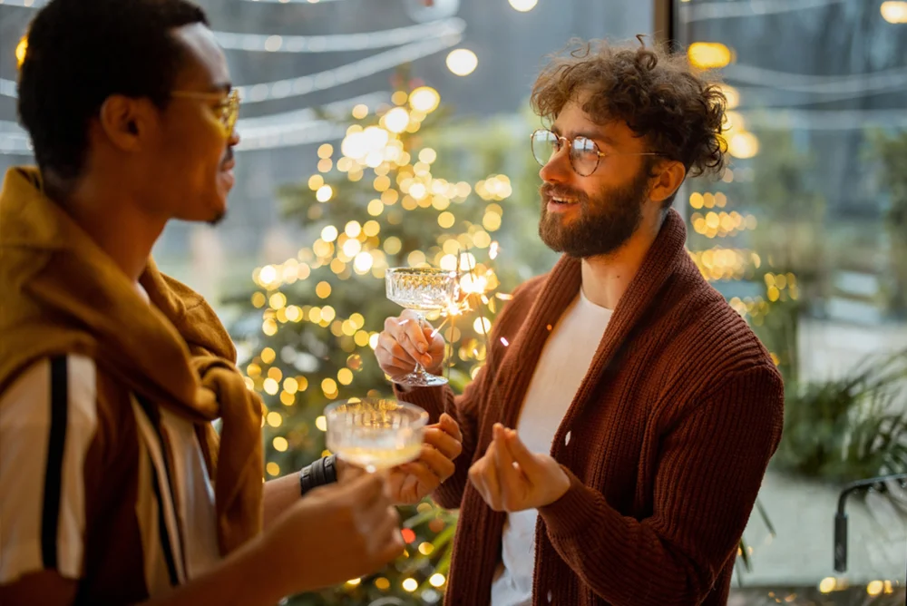 Gay couple at night celebrating with fairy lights in the background