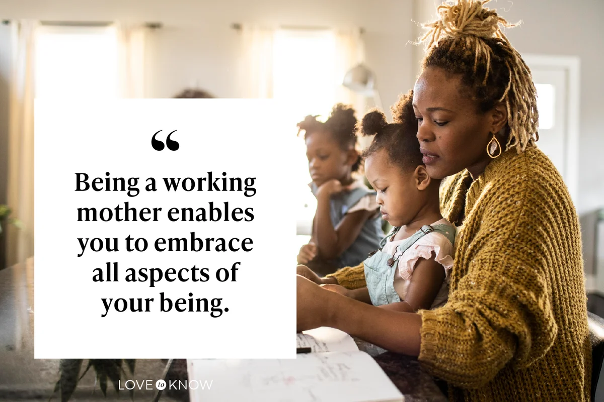 Mother working from home while holding toddler