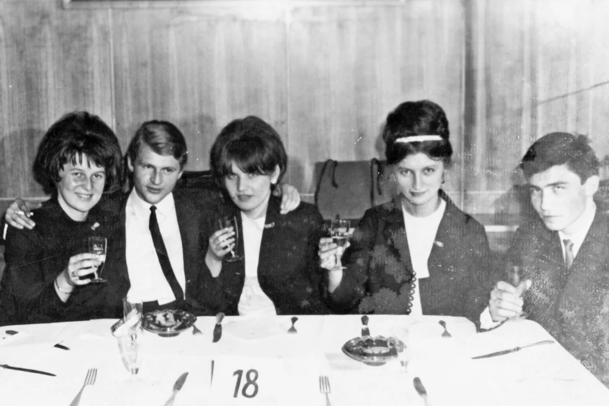Group of friends at a table in a restaurant in 1970