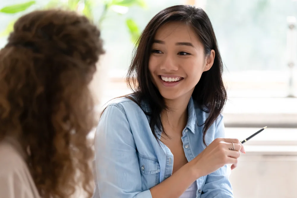 Two young girls talking to each other
