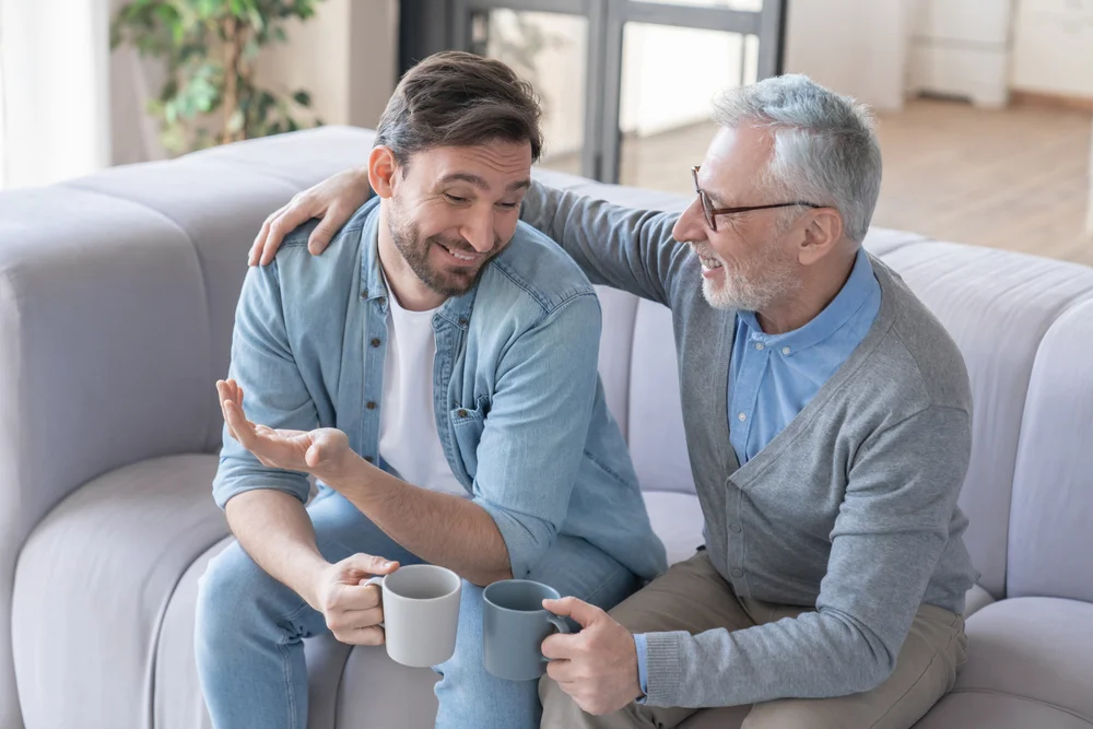 Two different generation men speaking to each other friendly