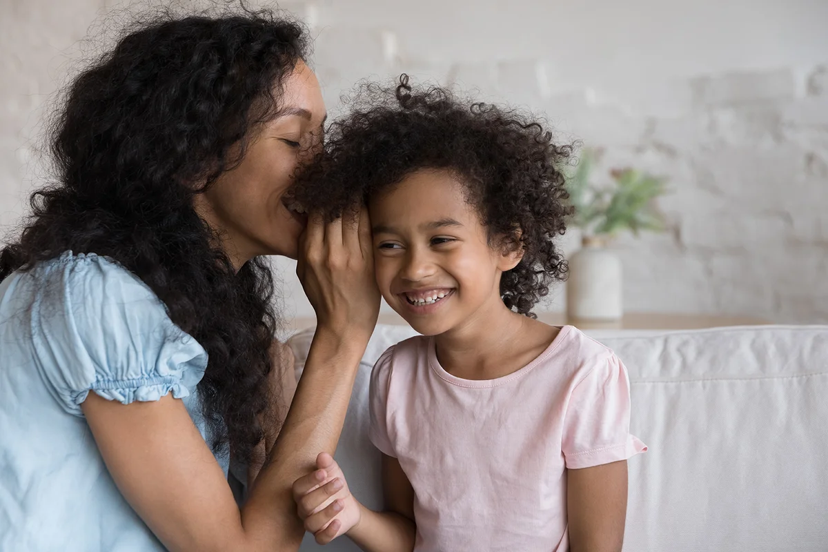 Mom and daughter talking on couch