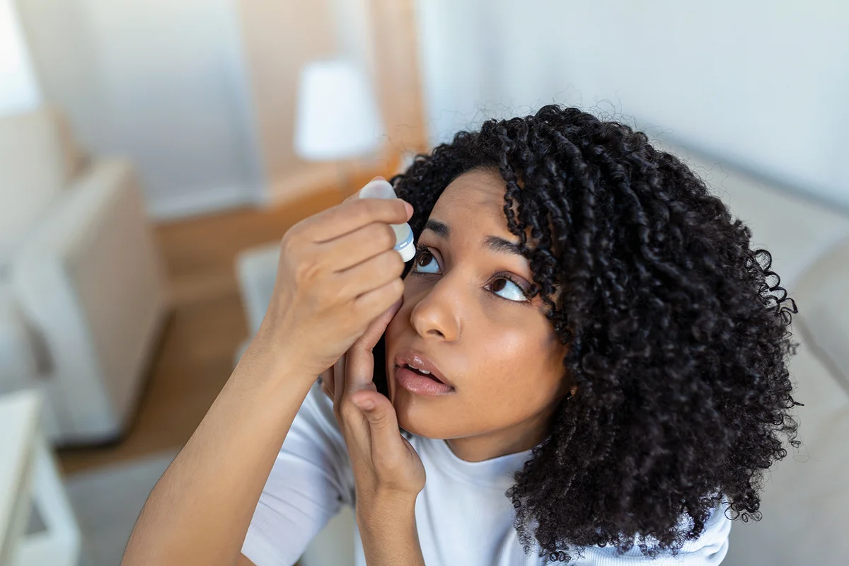 Woman applying eye-drops