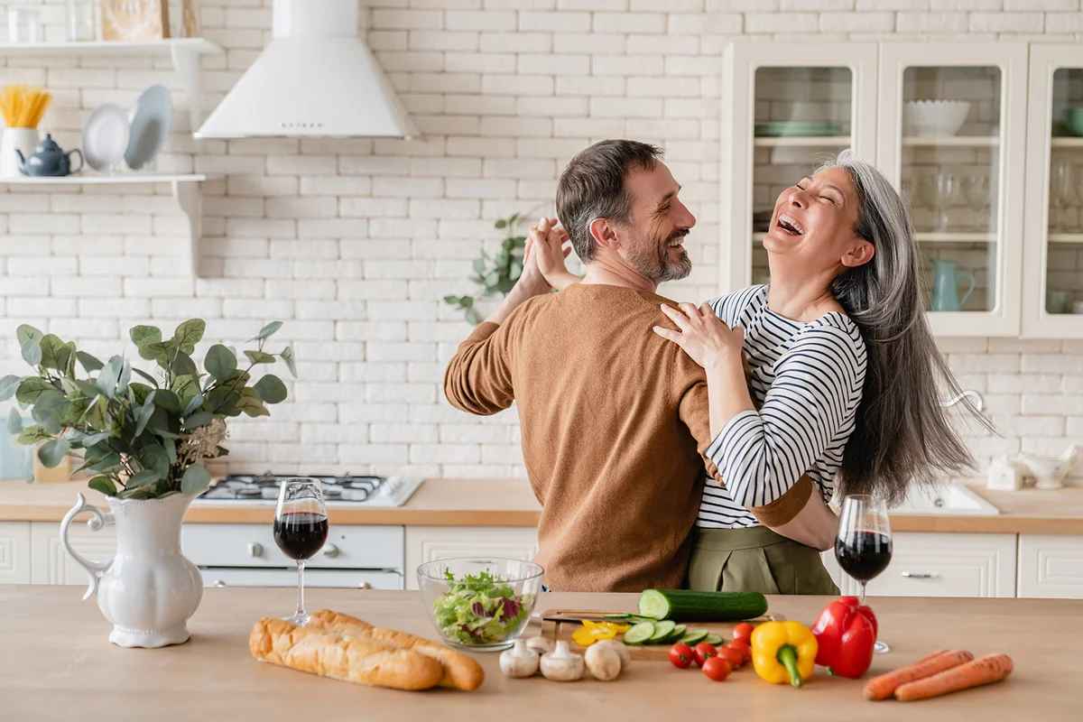 Happy couple dancing together in the kitchen
