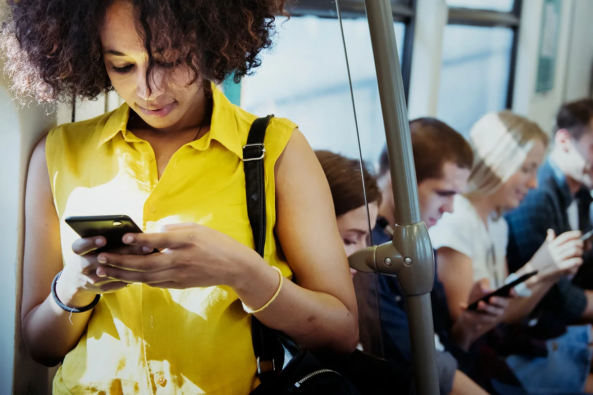 Young woman using a smartphone in a subway