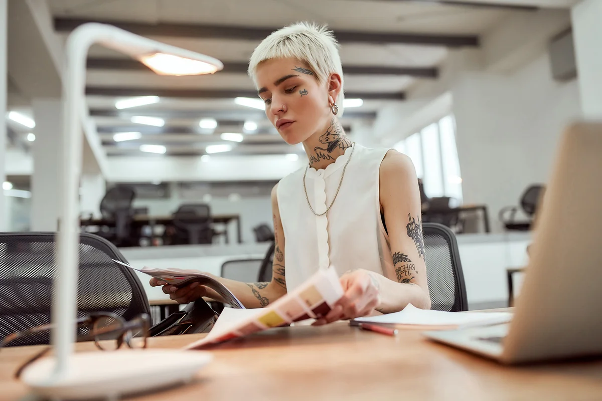 blonde tattooed businesswoman working