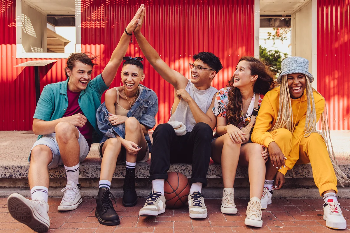 Group of multiethnic young people enjoying hanging out together