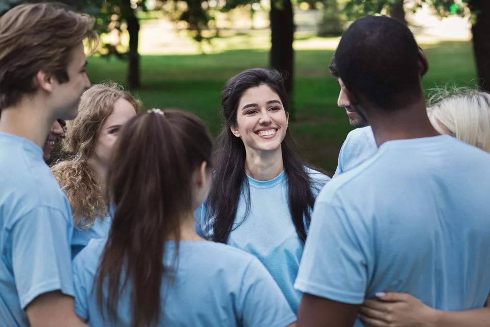 Group of teens having fun at the park with blue t-shirts