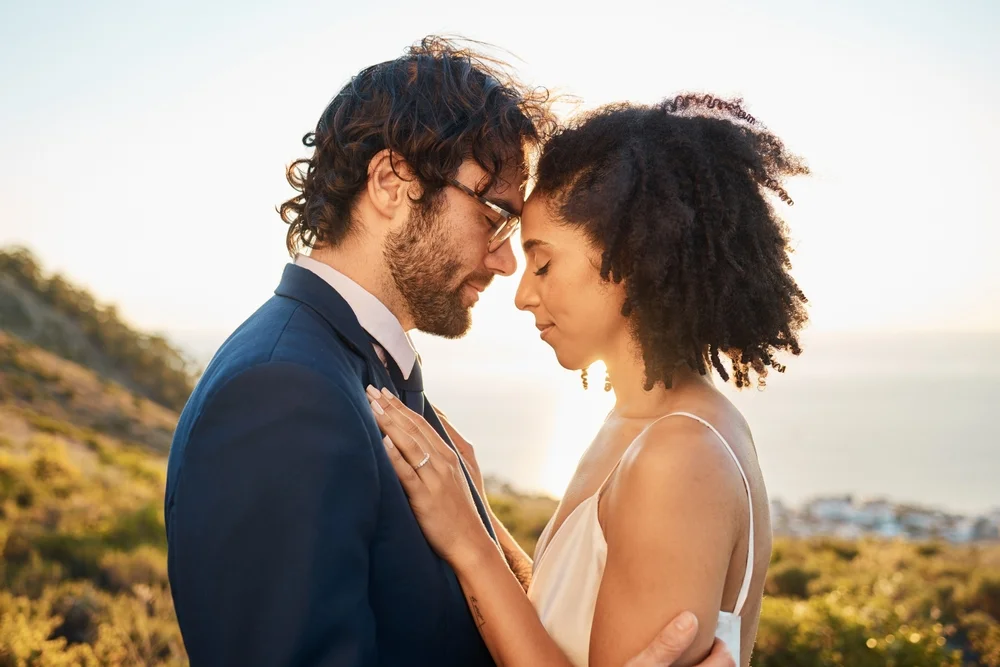 Interracial couple in love with a sunset view