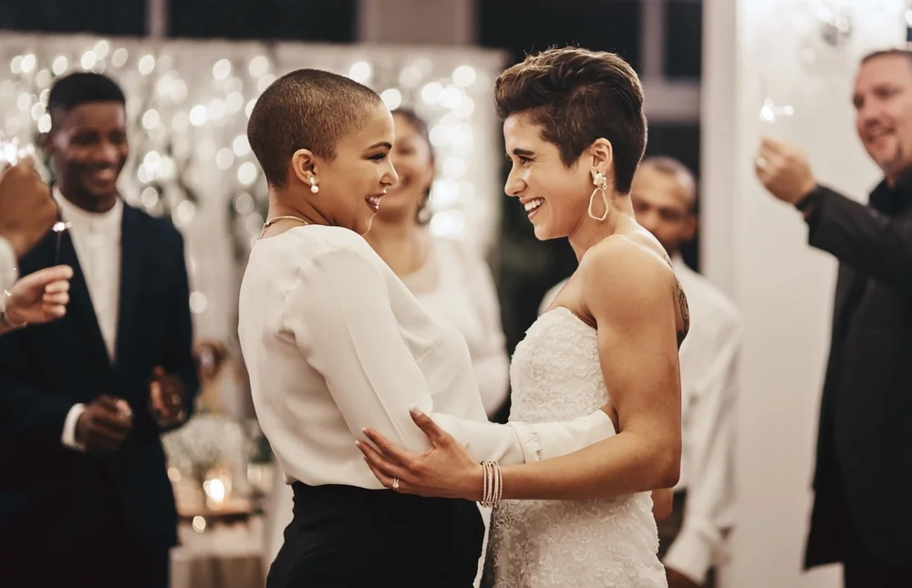 Couple of women dancing in their backyard wedding party
