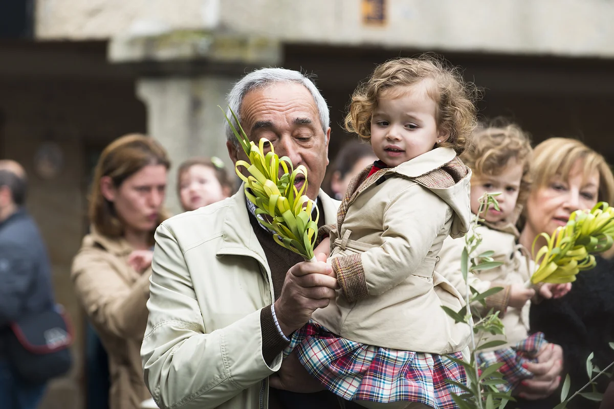 Detail of person participating in the celebration of Palm Sunday before Easter