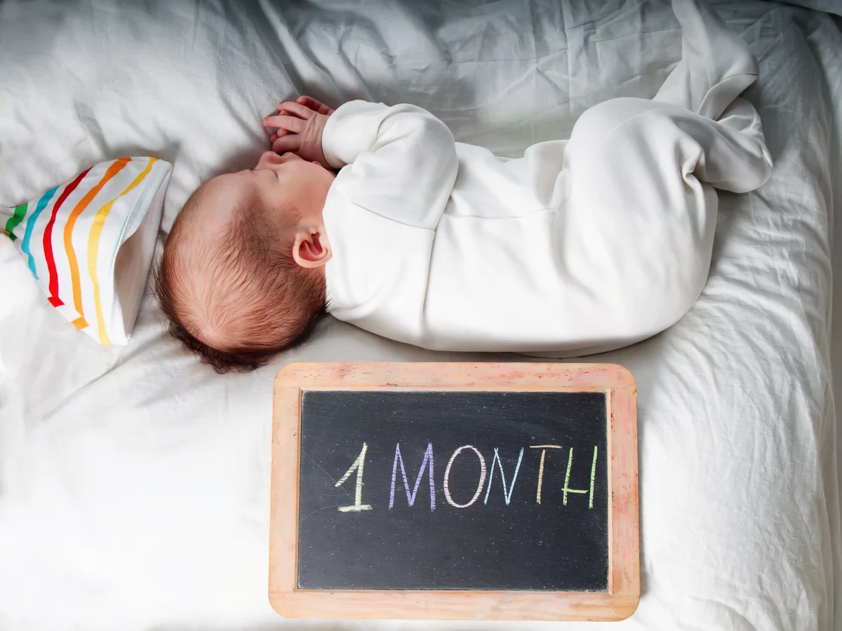 newborn baby toddler boy sleeping in his bed with toys