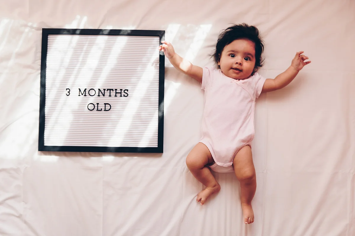 Baby girl with message board with text