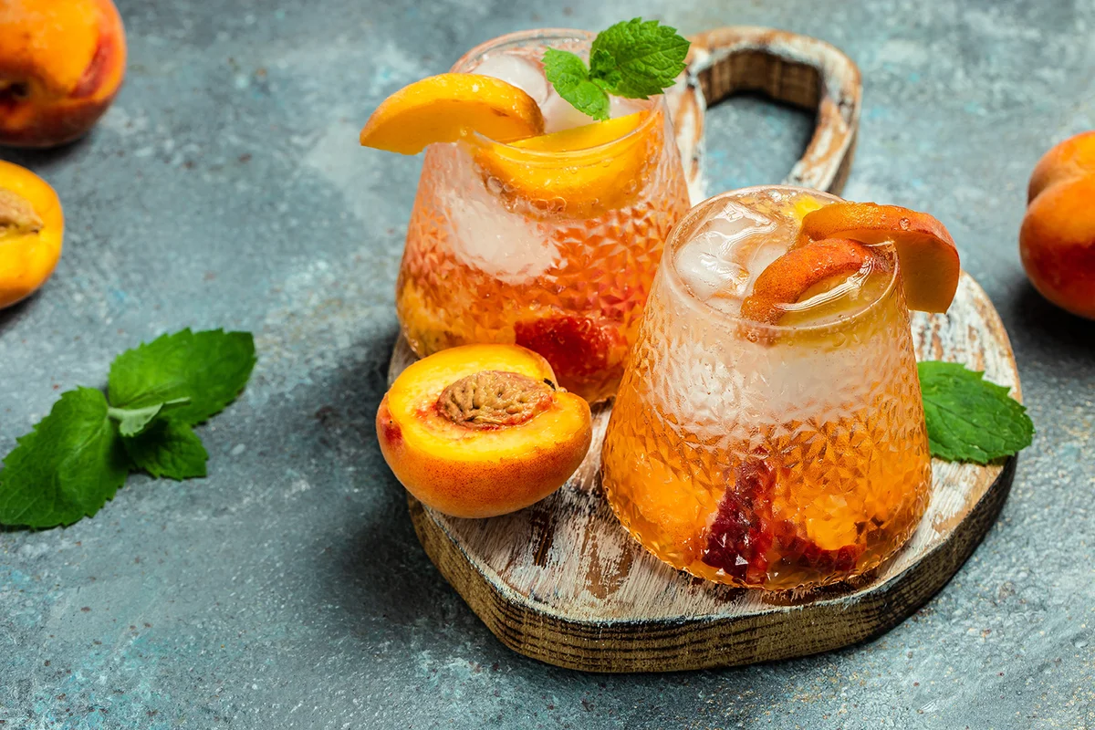 drinks peach, homemade peach cocktail with ice cubes