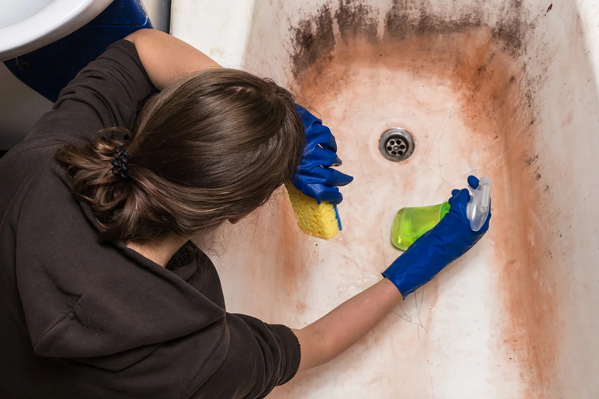 cleaning old dirty bathtub