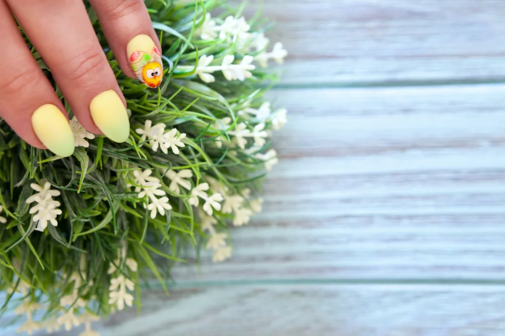 yellow nails with a decal