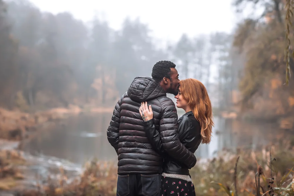 couple outdoors by a pond