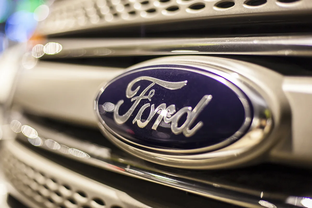 Ford company logo on a car illuminated at night