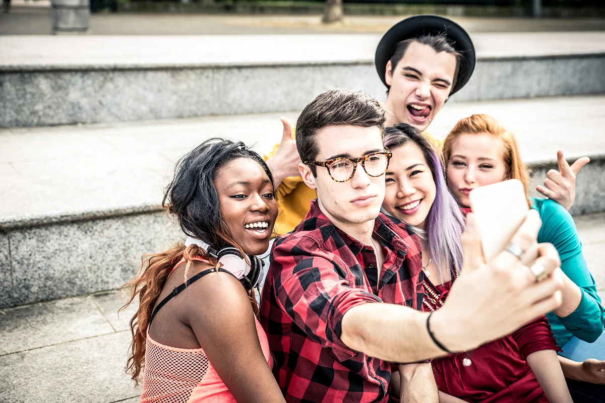 Teens taking selfie with phone