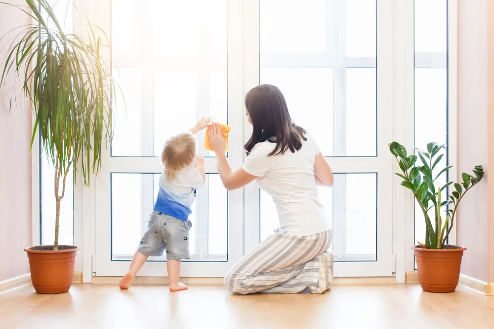 mom and baby cleaning house