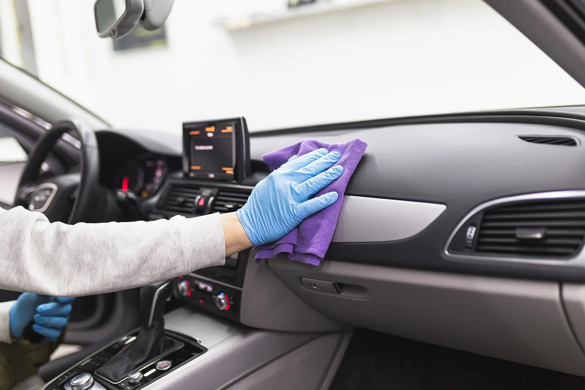 A man cleaning car interior