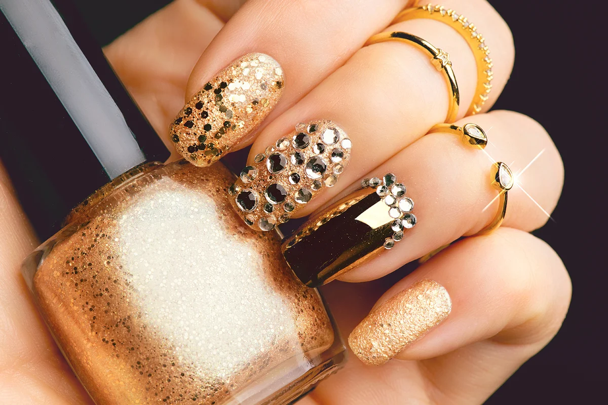 Golden Nail art manicure with gems and sparkles