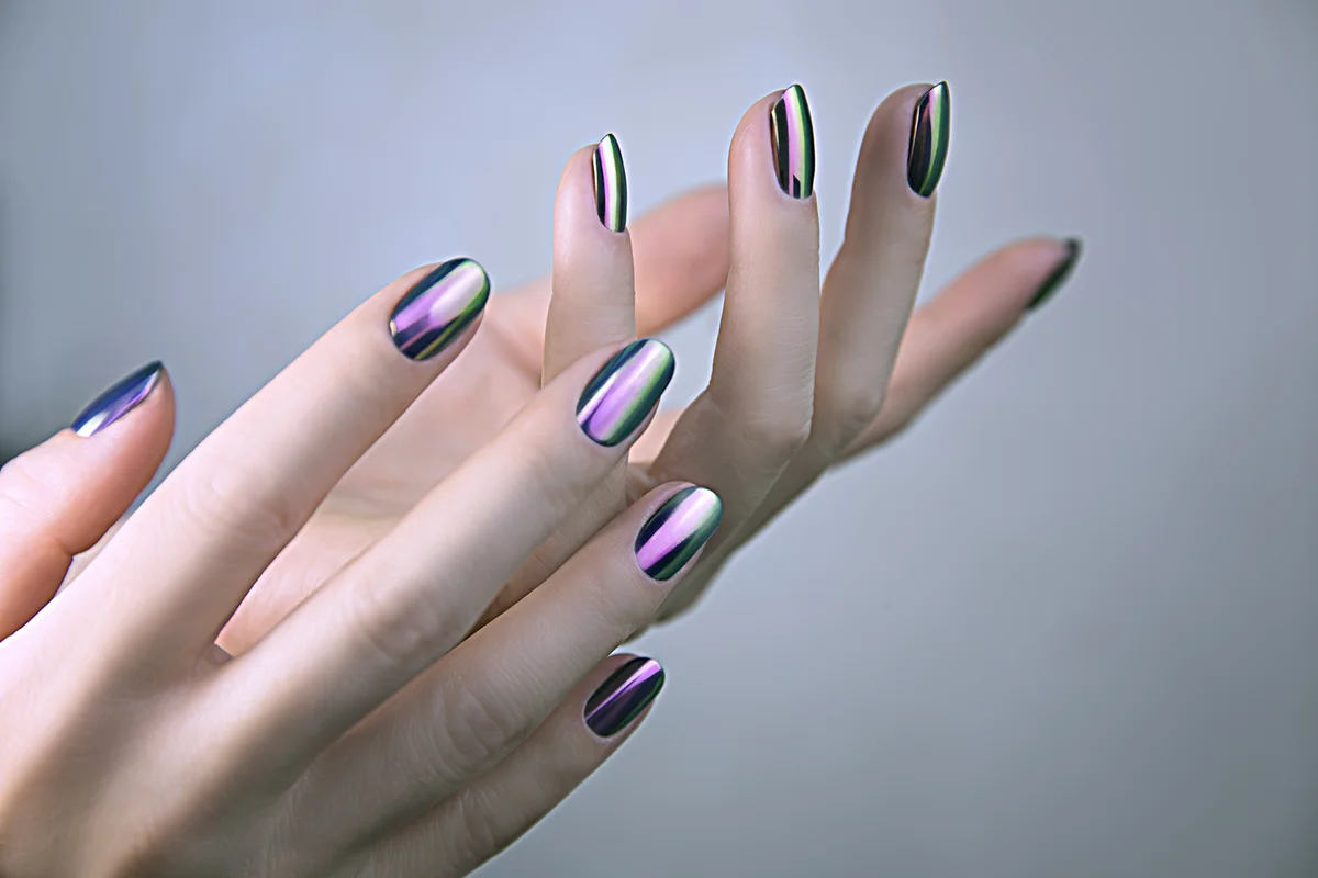 Stylish trendy female mirror manicure. Metal Nail Art. Chrome Nails.