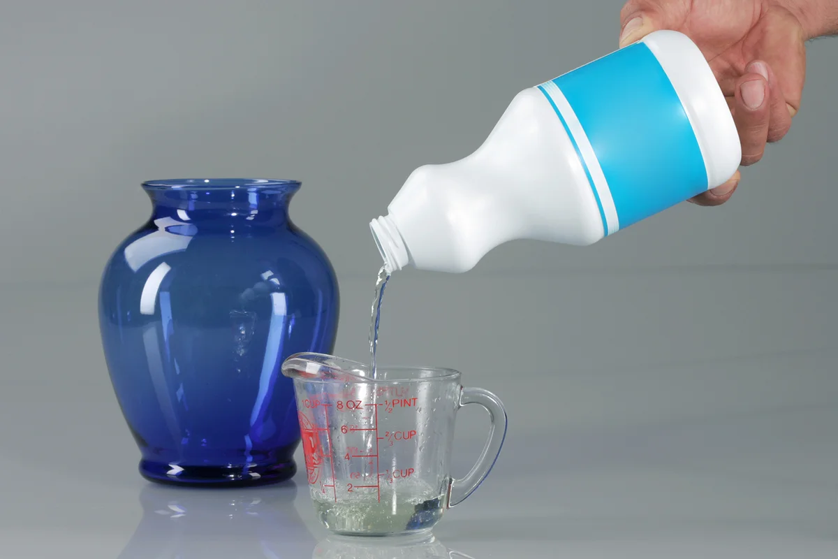 Pouring Bleach on Measuring Cup