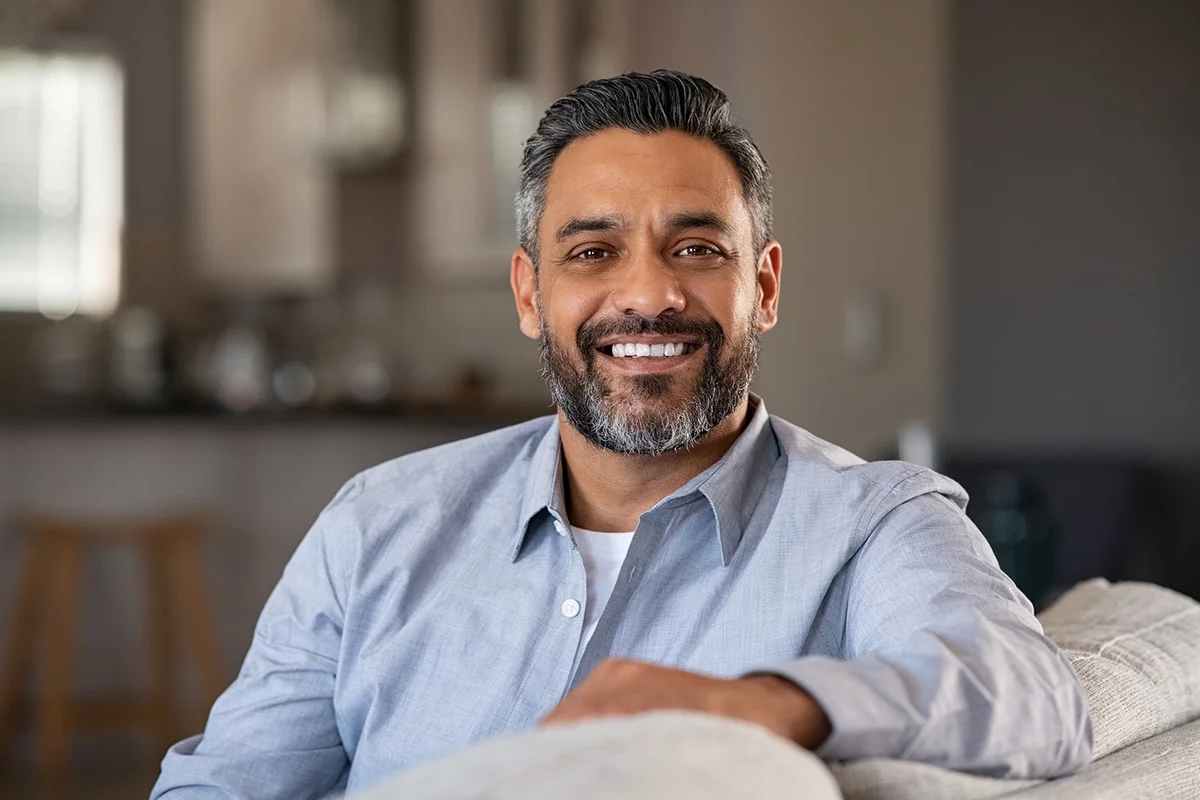 man sitting on sofa at home