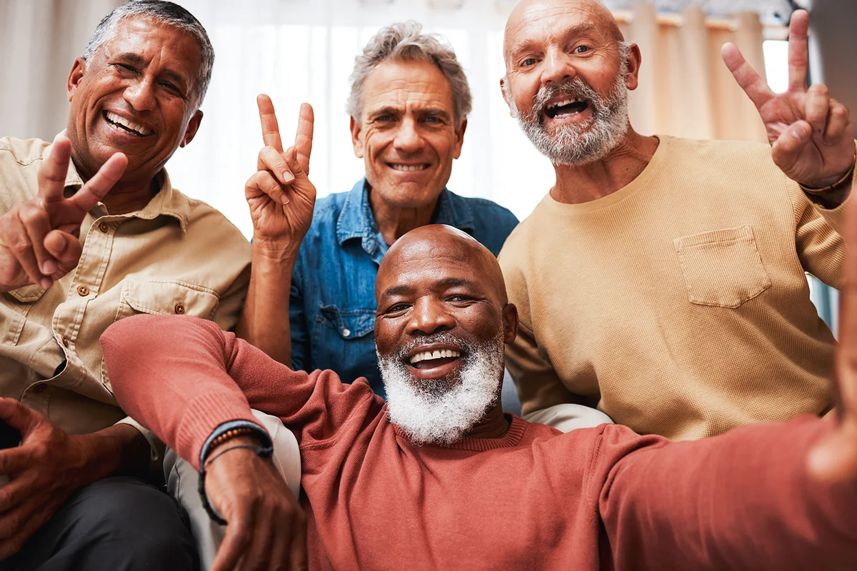 selfie of senior friends with peace sign in house