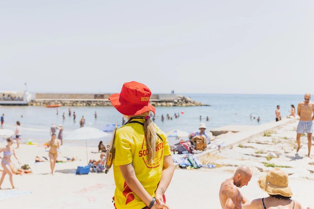 Lifeguard in working clothes guarding the beach