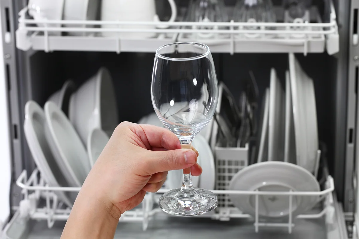 man hand taking out clean wine glass
