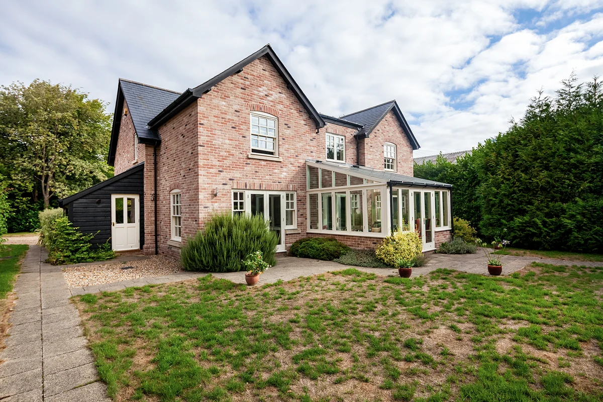 Luxury modern detached home with drought affected patchy dead lawn