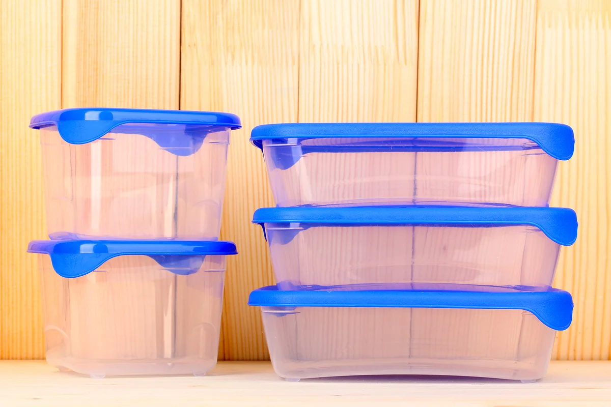 Plastic containers for food on wooden background
