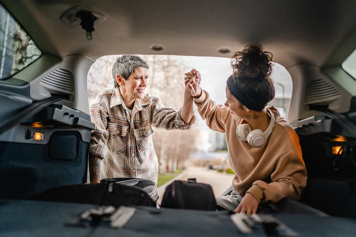 Mother helping daughter pack for college