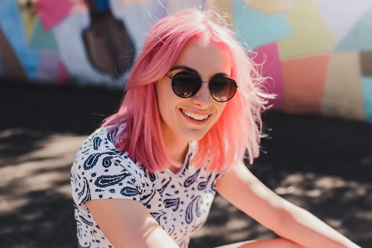 Sporty attractive woman with pink hair and healthy smile,