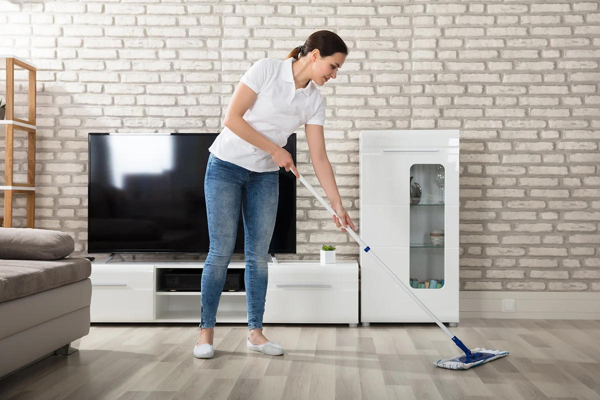 Woman Cleaning The Hardwood Floor With Mop