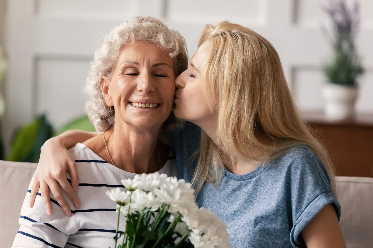Affectionate daughter greeting happy mom
